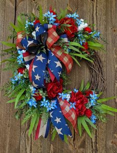 a patriotic wreath with red, white and blue flowers