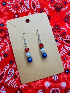 Simple earrings with a big bang! Perfect for your Fourth of July get together's or your memorial day cookouts or just whenever you're feeling patriotic!  They feature three glass beads; red, pearl, and blue.  They are on an ear wire with three different metal options. All sales final. 4th Of July Beaded Earrings, 4th Of July Earrings, Patriotic Earrings, Patriotic Jewelry, Red Pearl, Wire Wrapped Earrings, Bead Jewellery, Simple Earrings, Bead Earrings