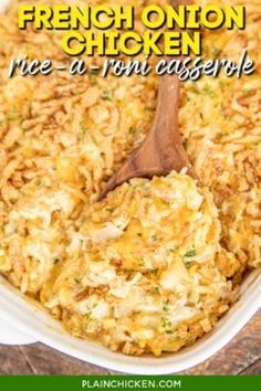 french onion chicken rice casserole in a white dish with a wooden spoon on the side