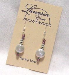 BEADED DANGLE EARRINGS OF FRESH WATER PEARLS by LUNASEA TREASURES OF NEW ENGLAND.  DESIGN INCLUDES A 10mm COIN SHAPED WHITE PEARL EMBELLISHED WITH THREE 2mm POTATO SHAPED RASPBERRY PURPLE PEARLS, ACCENTED WITH STERLING SILVER BALL & RONDELLES.  EARRINGS DANGLE 7/8" FROM FRENCH EAR WIRES.   ALL FINDINGS ARE STERLING SILVER.  SAFETY BACKS ARE INCLUDED. Froo www.froo.com | Froo Cross Sell, Free Cross Sell, Cross promote, eBay Marketing, eBay listing Apps, eBay Apps, eBay Application White Raspberry, Artisan Jewelry Earrings, Purple Pearl, Fresh Water Pearls, Handcrafted Artisan Jewelry, Water Pearls, Beaded Dangle Earrings, Beaded Dangles, Earrings Dangle