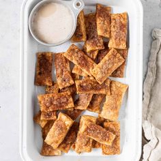 tofu sticks with dipping sauce in a white tray