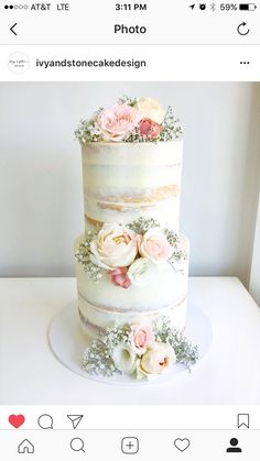 a three layer cake with flowers on top