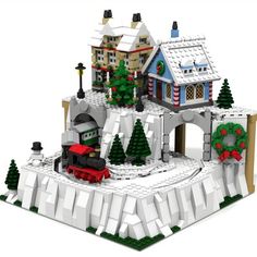 a lego snow village with a train on the tracks