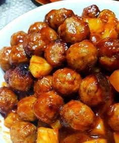 a white plate topped with meatballs covered in sauce