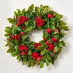 a wreath with red roses and green leaves