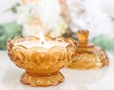 two golden candles sitting on top of a table