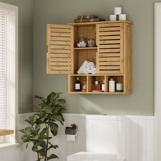 a wooden cabinet above a toilet in a bathroom