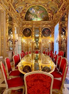 an ornate dining room with gold and red chairs