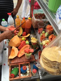 a person cutting up some food on top of a table