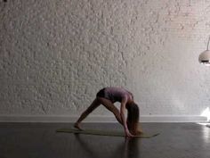 a woman is doing yoga on the floor