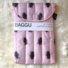 the baggi laptop sleeve is pink with black bugs on it and has a tag that says, 16 - puffy laptop sleeve