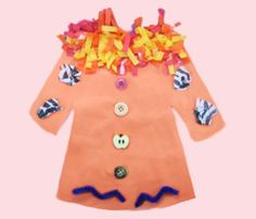 a child's dress made out of paper and buttons