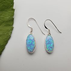 Visit our on-line shop at: Etsy.com/shop/925ForHer *sterling silver earrings *dangles / drops / hooks / ear wires *southwestern jewelry *blue opal / lab created *calibrated pre-cut stones and shapes: 14x7mm oval shape *back of jewelry items are all covered / do not show the back of stones *all jewelry items are made to ship, slight variations in stones will occur comparing to pictures. *size of a penny is 19mm or a dime is 18mm in diameter for comparing size with jewelry items. *handcrafted in U Blue Opal Jewelry, Opal Earring, Blue Opal Earrings, Fire Blue, Jewelry Blue, Southwestern Jewelry, Earrings Dainty, Line Shopping, Opal Earrings