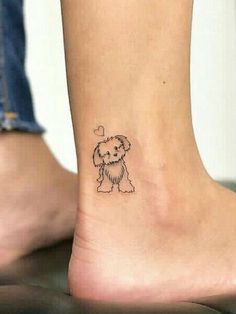 a small dog tattoo on the ankle