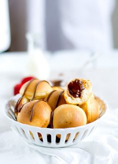 a white bowl filled with pastries on top of a table