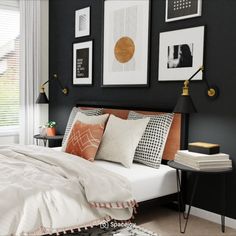 a bedroom with black walls, white bedding and pictures on the wall above it