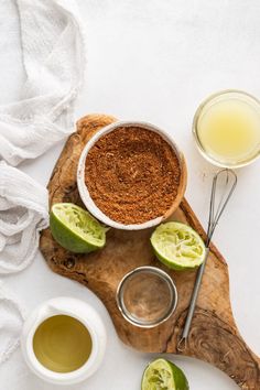 an overhead view of some ingredients on a wooden cutting board with spoons and cups