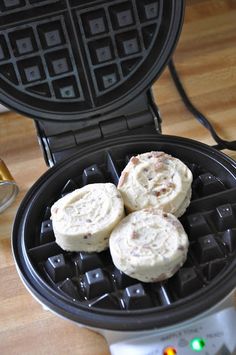 three waffles sitting on top of a pancake maker