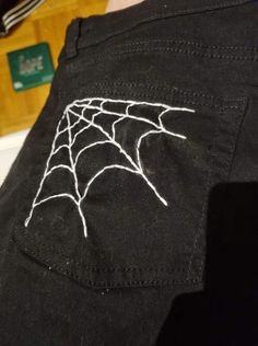 the back of a person's shirt with a spider web on it