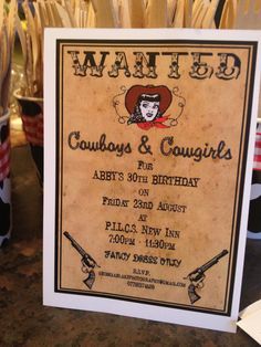 an old wanted poster is displayed on the counter in front of many knives and other items