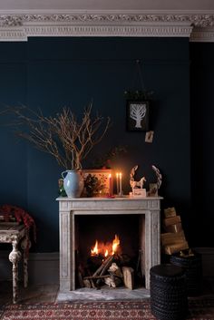 an image of a fireplace with candles on it and other decorations around the fire place