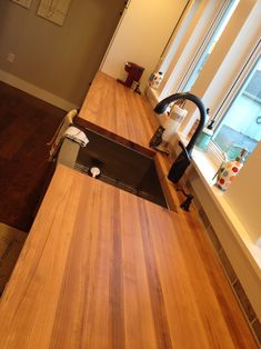 an empty kitchen with wooden counter tops and appliances