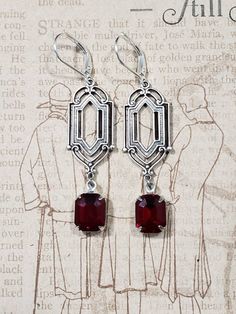 These Deco dangles are the perfect earrings for a 1920s themed wedding or party. Red vintage glass beads dangle from silver plated brass Art Deco style connectors. The silver plated brass stampings have an ornate front and a reverse side that is slightly hollow. (SEE 2nd PHOTO) These earrings are lightweight (lobe friendly) yet sturdy, free of lead and nickel. The earrings measure 2 1/4 inches long from the top of the ear wires to the bottom of the glass beads. They hang from silver plated lever Victorian Dangle Earrings For Party, Vintage Formal Filigree Chandelier Earrings, Victorian Dangle Chandelier Earrings For Parties, Victorian Chandelier Dangle Earrings For Party, Vintage Red Dangle Chandelier Earrings, Red Vintage Dangle Chandelier Earrings, Red Vintage Chandelier Dangle Earrings, Victorian Style Party Chandelier Earrings, Nickel Free Elegant Red Chandelier Earrings