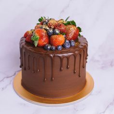 a chocolate cake with fresh fruit on top