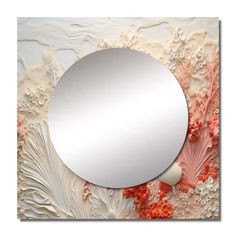 a round mirror mounted to the side of a wall with corals and shells on it