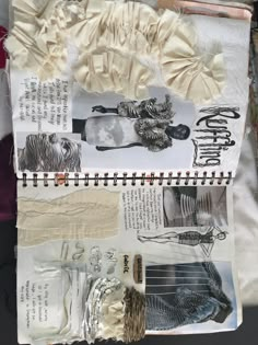 an art journal with paper, fabric and other items on it's cover sheet