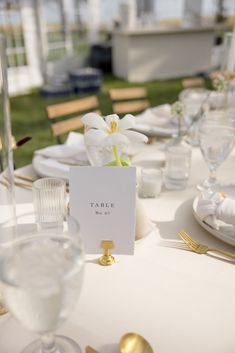 the table is set with place cards and silverware