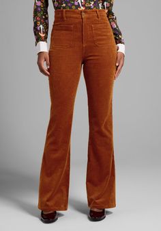 In a marvelous medley of styles, these vintage-inspired mariner pants combine a 70’s flare-leg silhouette with a fall-fabulous corduroy construction. Presenting in a cinnamon hue, these slightly stretchy high-rise pants from our ModCloth namesake label boast front and back patch pockets and a retro-chic flared leg finish. 98% Cotton, 2% Spandex. Front and back patch pockets. Flare leg. High-rise. Button and zip closure. Fabric provides stretch. Machine wash cold. Lay flat to dry. Imported Model 1960s Pants Women, Mid Century Modern Fashion Woman, 1970s Style Women, 1960s Outfits For Women, Holiday Party Pants, Vintage Retro Outfits, 1960s Pants, Plus Size Vintage Clothing, 60s Mod Fashion