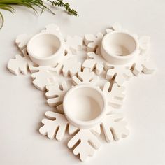 four white snowflakes sitting on top of a table next to each other