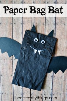 a black paper bag with a bat cut out of it and text overlay that says how to make a paper bag bat