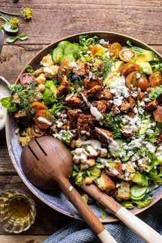 a salad with chicken, tomatoes, cucumbers and feta cheese in a bowl