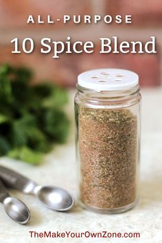 an all purpose spice blend in a glass jar with two spoons next to it