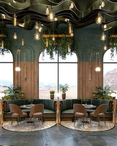 a room filled with lots of tables and chairs next to large windows covered in plants