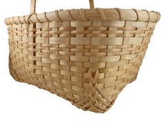 a large woven basket with handles on a white tableclothed surface, ready to be used as a purse