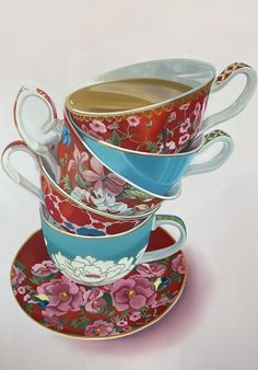 three teacups stacked on top of each other with saucers and spoons