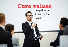 a man standing in front of a whiteboard giving a presentation to his colleagues at the same time