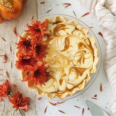 there is a pie with orange flowers on the table