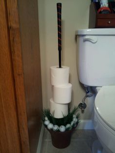 a toilet with three rolls of toilet paper stacked on top of it