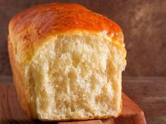 a loaf of bread sitting on top of a wooden cutting board