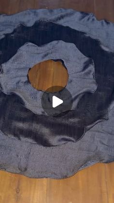 a piece of cloth on the floor with a hole cut out to show what is inside