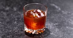 a glass filled with liquid sitting on top of a table