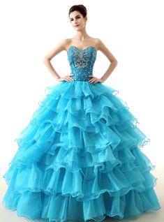 Rule hearts with this exquisite looking quinceanera dress. a tight fitted bodice festooned with beadings and crystals form the upper part of the dress. below the body-hugging bodice is the voluminous skirt with a hemline that reaches to the floor. The skirt features tiers of ruffled organza making it stand out from the rest. Backless style of the back gives it a touch of sexy and the embellishments make it look as gorgeous as the front. A laced up back makes sure that the dress fits your body perfectly and accentuates the curves of your slender waistline. The sheer color of the dress gives it an artistic finish. Las Vegas Dress, Girls Pageant Gowns, Cheap Quinceanera Dresses, Purple Quinceanera Dresses, Sleeveless Chiffon Dress, Quinceanera Dresses Blue, Prom Ball Gown, Quinceanera Dress, Ball Gowns Evening