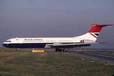 a british airways plane is on the runway at an airport with grass and trees in the background