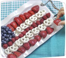 a white plate topped with fruit and pretzels