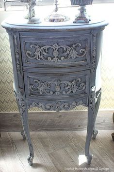 an ornately painted dresser in front of a window