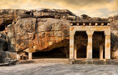 the entrance to an ancient city surrounded by large rocks and boulders with text that reads, bhubaneswar city of temples